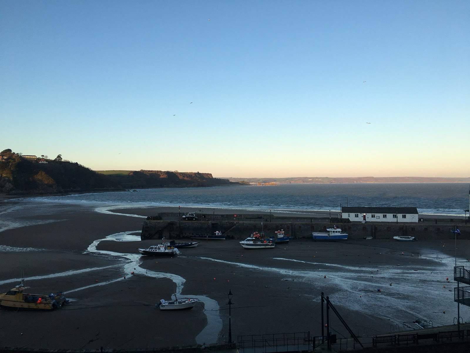Boats in Tenby harbour at sunset